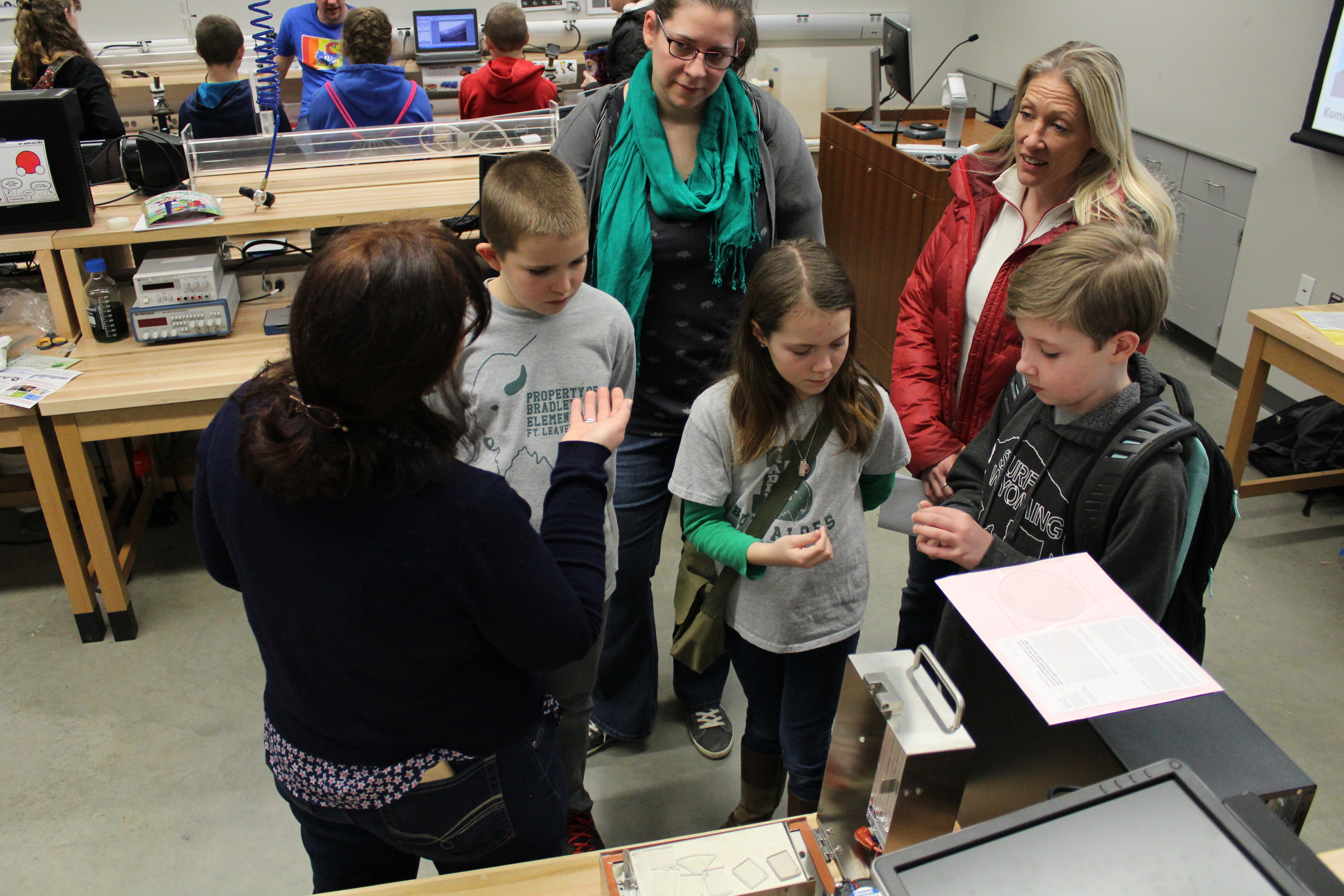 A group of students being instructed by a helper.