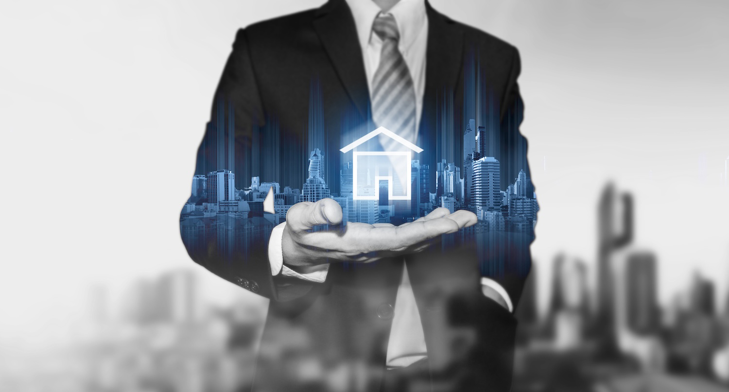 Rendering of a person in a suite with a home icon hovering over their extended hand