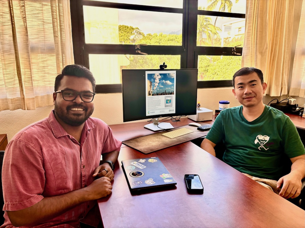 Allen and Rui at a desk smiling