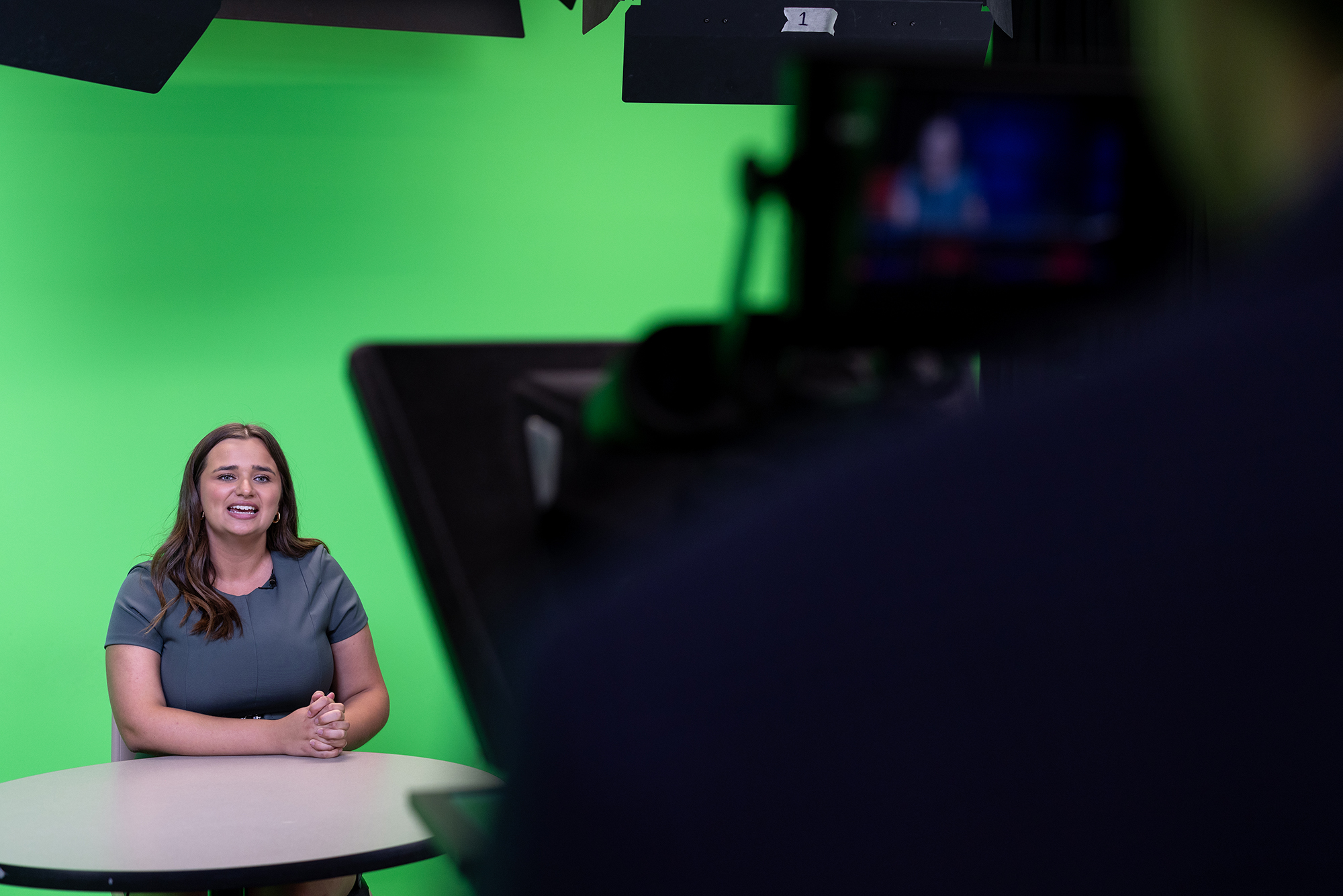 Sydney Clark on set in front of a camera