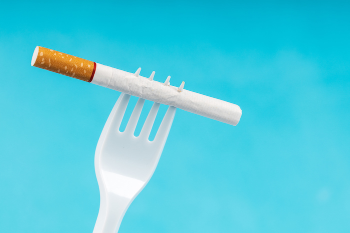 Tobacco and plastic fork illustration.