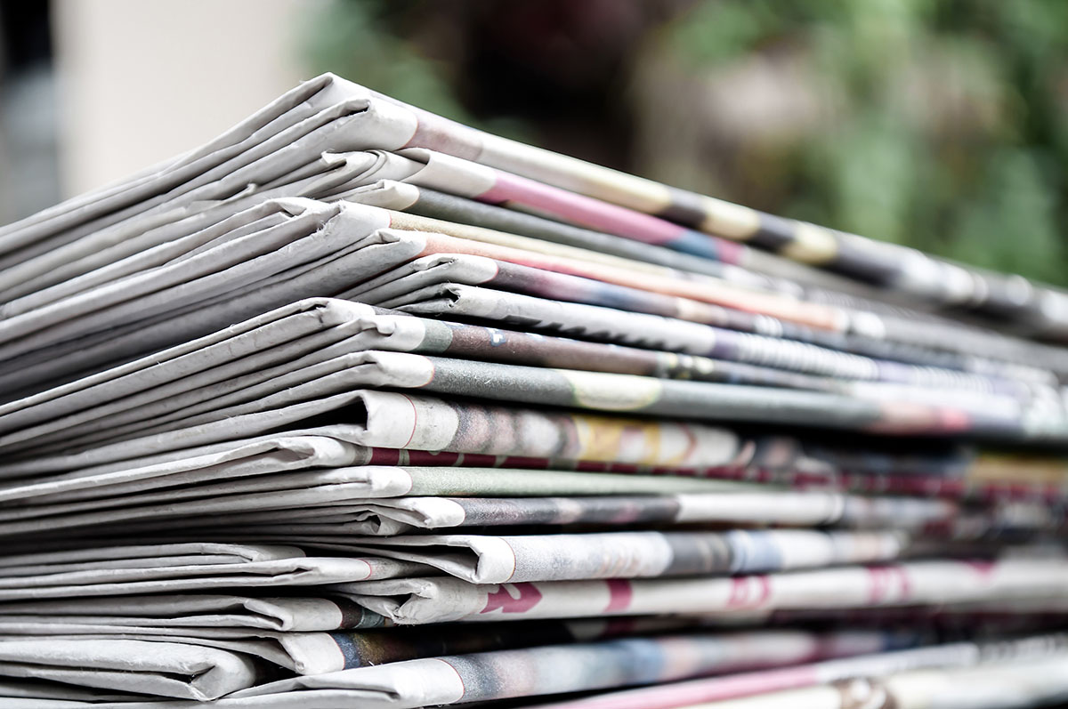 An image of a stack of print newspapers.