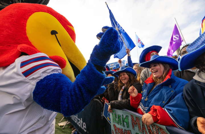 Baby Jay and football fans celebrate at a KU football game.