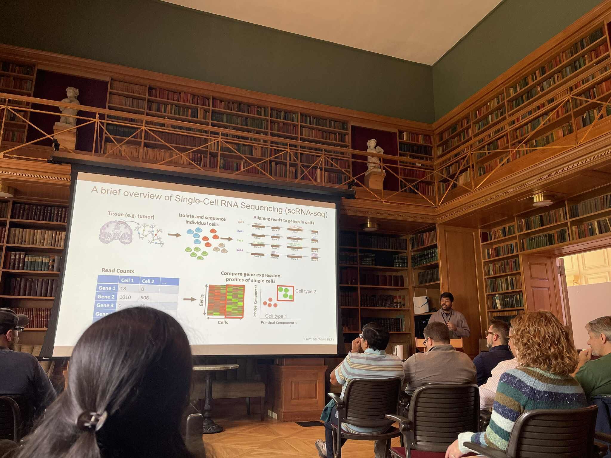  Nilanjan Roy presents his research in front of a crowd.