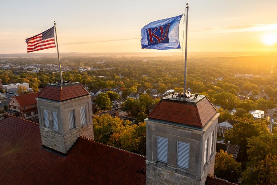 KU, American flags fly atop Fraser Hall.
