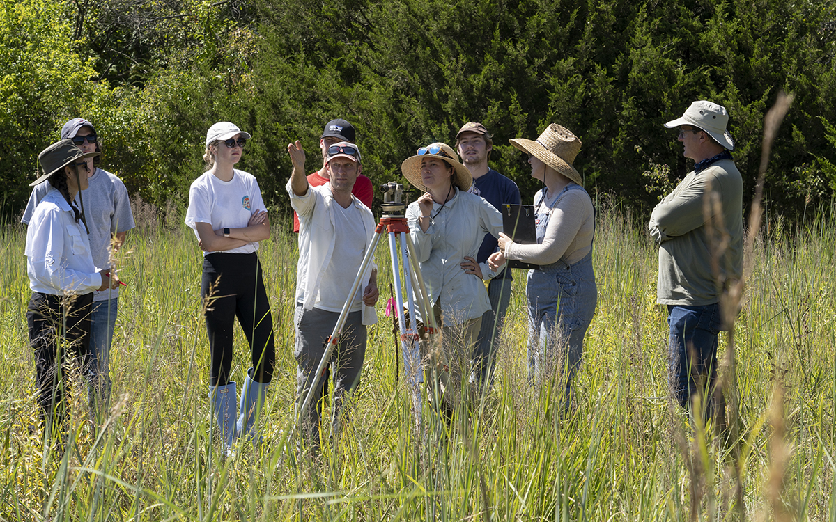Artist Janine Antoni (far left) works with Keith Van de Riet, University of Kansas associate professor of architecture, Sheena Parsons, Station Manager, KU Field Station, and students from Van de Riet’s architecture class on the creation of here-ing.