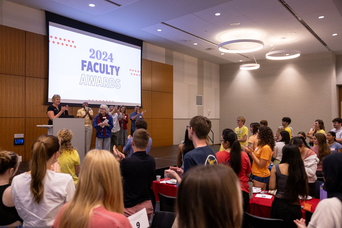 Audience stands and applauds for award recipient on stage