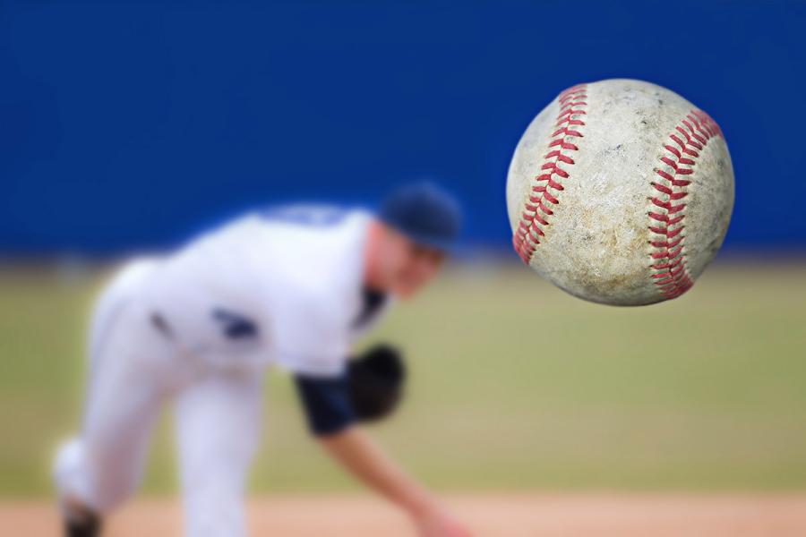 An image of a baseball being thrown by a pitcher, shown in the background.