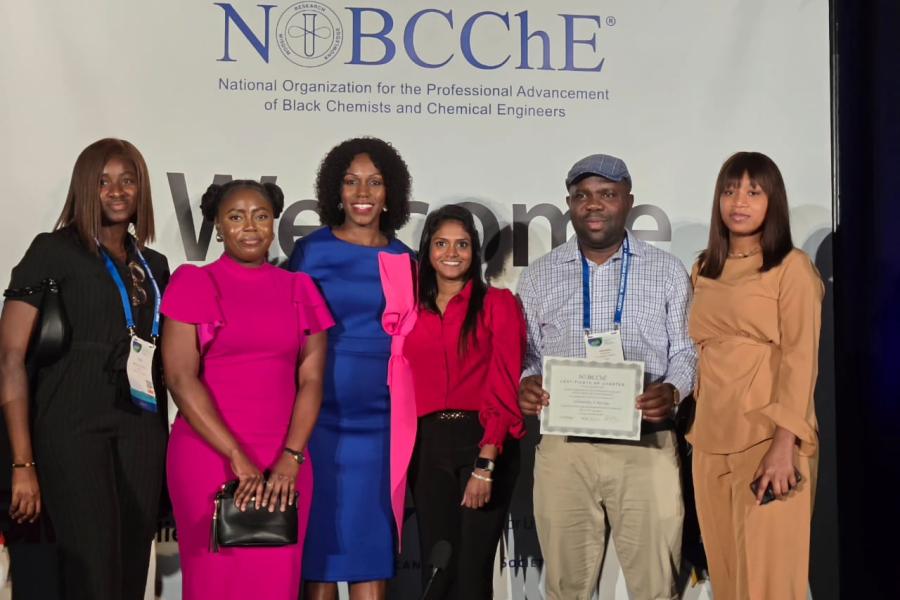 KU-NOBCChE members and the national organization's president on stage with the certificate of charter.