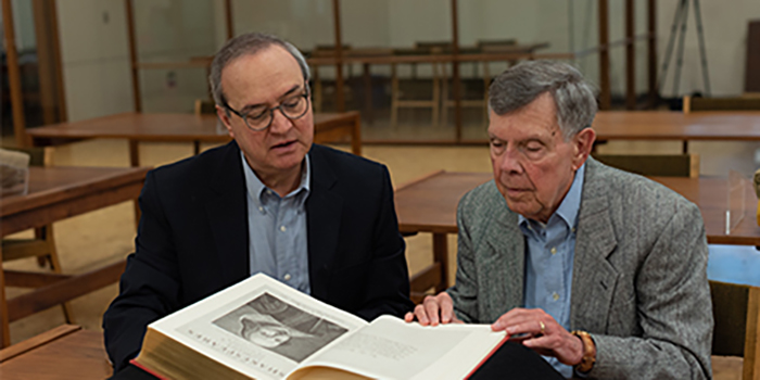 Geraldo Sousa, left, and David Bergeron look over Shakespeare materials in KU's Spencer Research Library. The two Shakespeare scholars recently made a gift to KU to establish an annual exhibition, and the first marks the 400th anniversary of Shakespeare's first folio, which collected many of his plays in print for the first time.  Image credit: Nikki Pirch