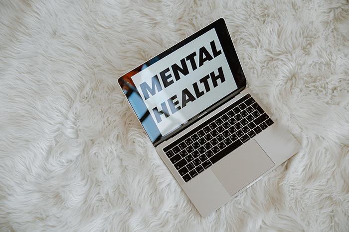 Laptop with "mental health" on screen. Credit: Pexels.