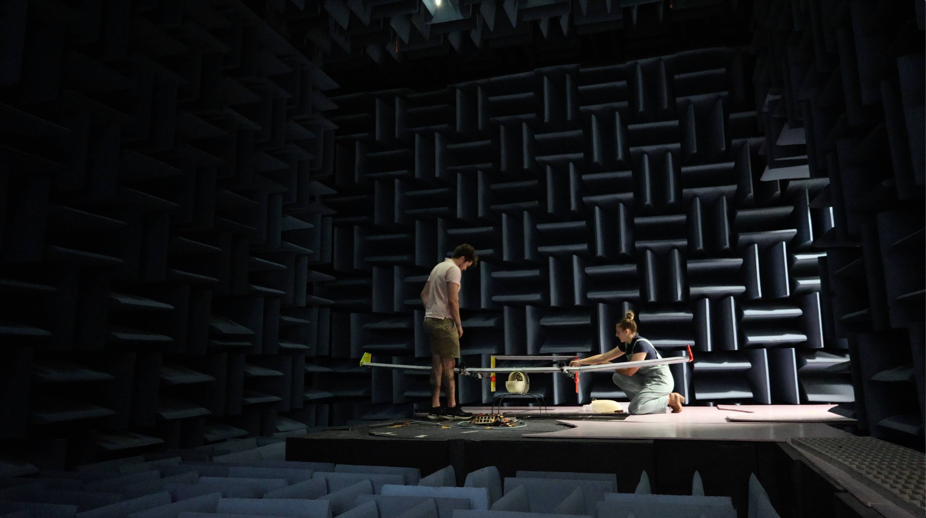 Aaron McKinnis and Anastasia Byrd work on an aircraft in an Anechoic Chamber