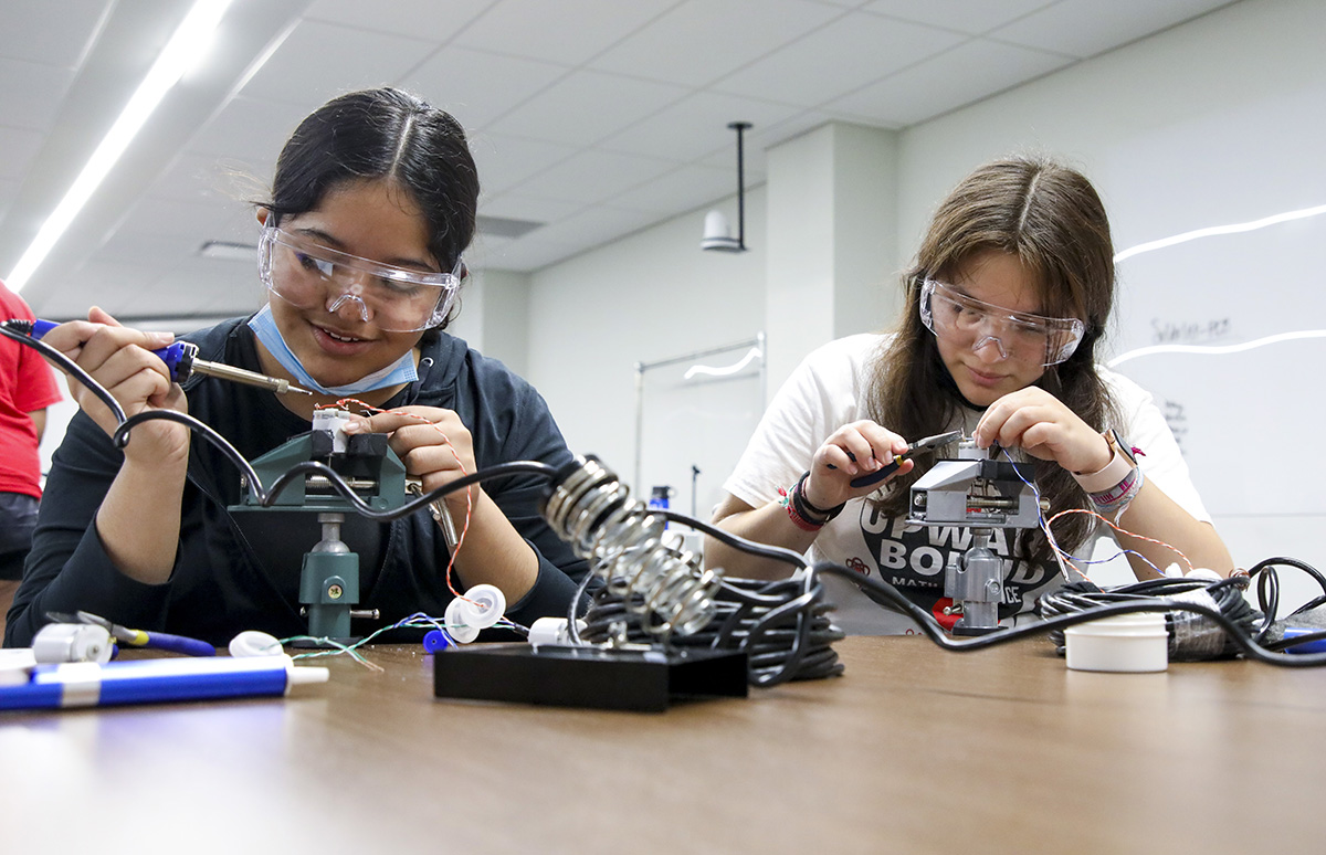 Two KU TRIO Upward Bound students build underwater robots during an afternoon STEM activity during the six-week long Non-Bridge Summer Institute. Credit: Laura Kingston.