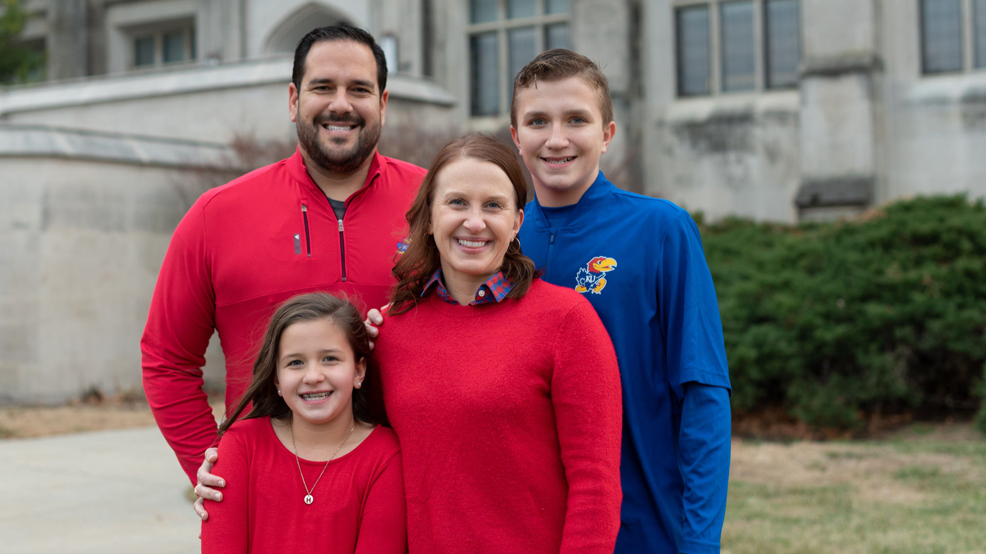 The Lewis family poses for a photo in front of Watson Library. 