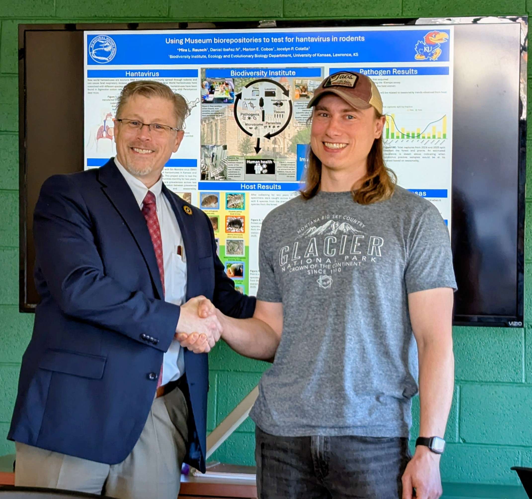 Ric Steele Jr., Committee Chair, presents EBB PhD student Ben Wiens with KU’s Graduate Student Distinguished Service Award.