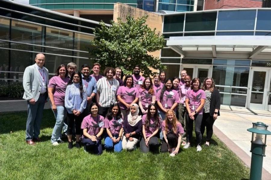 Kiana Hajiarbabi in a group photo with other atendees of the conference, they all wear matching conference tshirts.