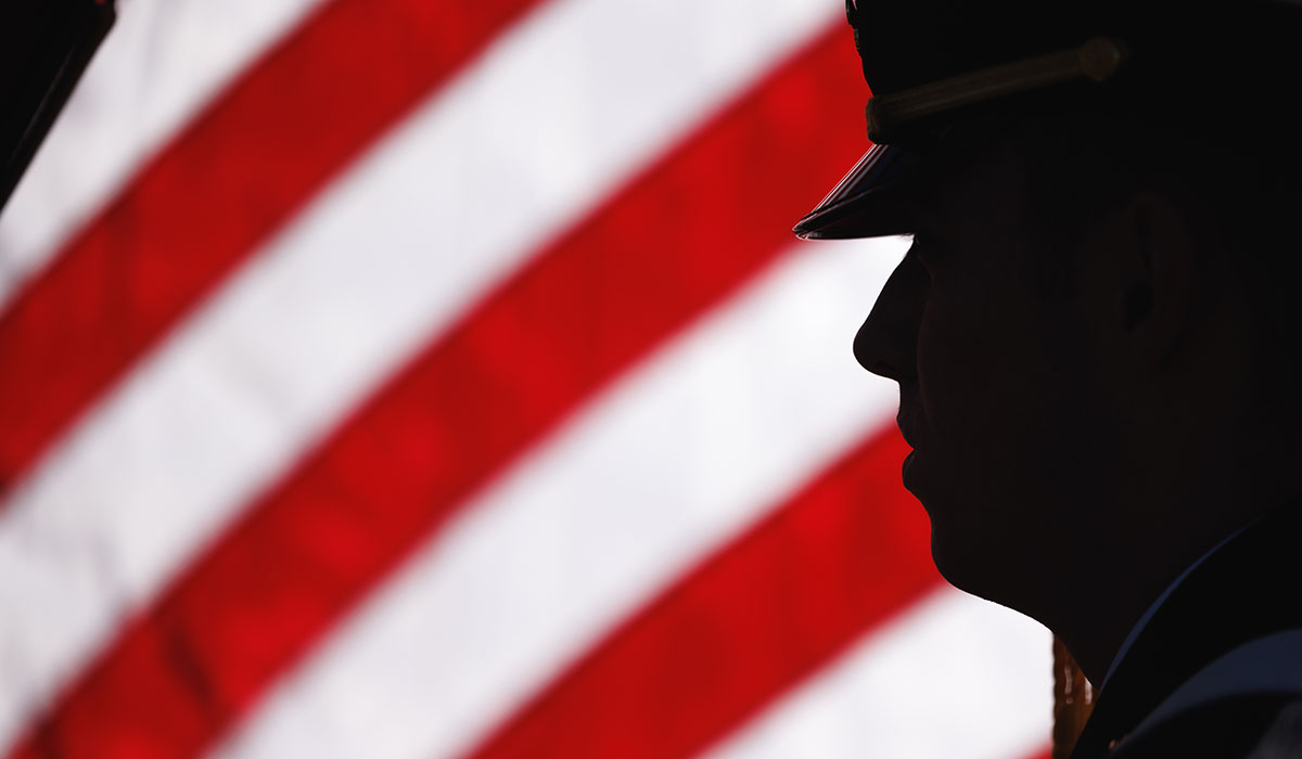 Silhouette of cadet in front of American flag