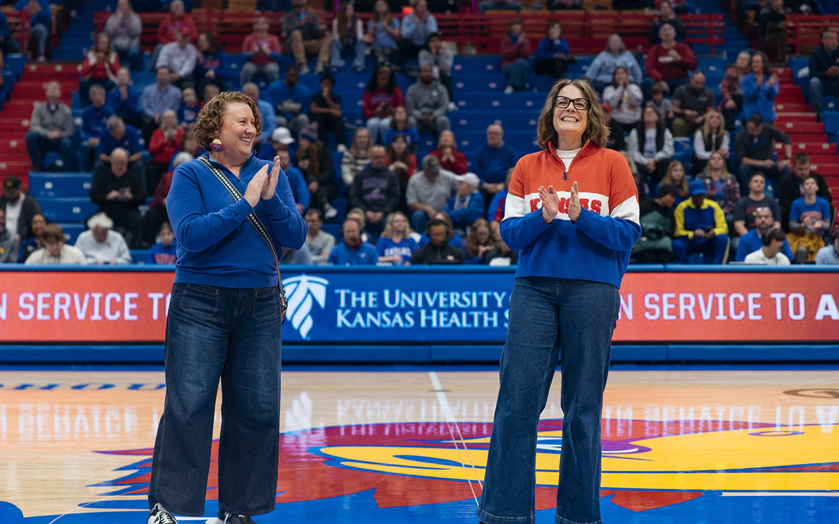 Lisa Didion and Jennifer Kurth cheer on the court of Allen Fieldhouse