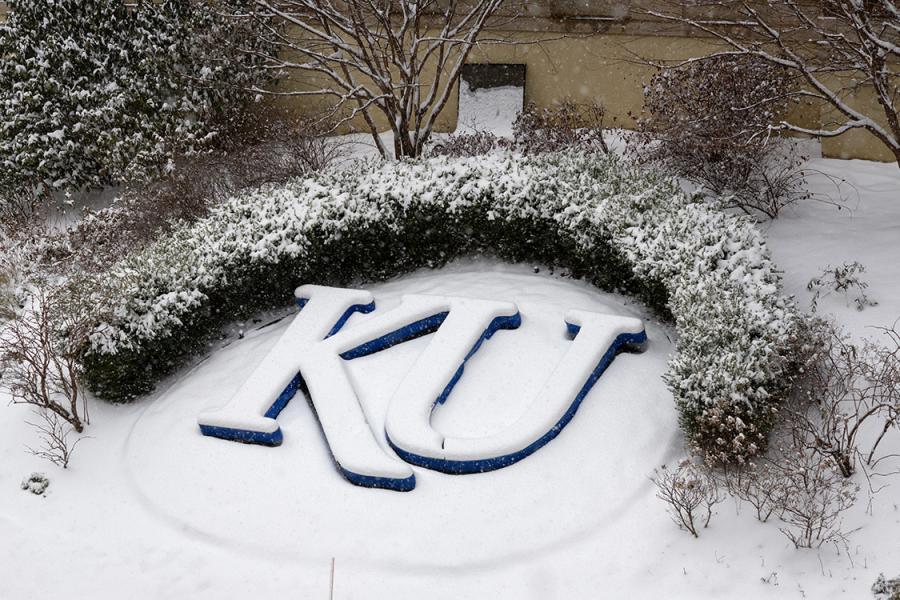 Snow covers the KU logo in the garden at KU Medical Center.