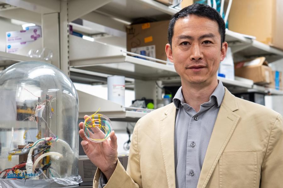 Yanliang standing in a lab
