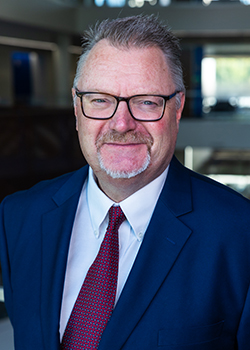 Professional headshot of Vince Barker