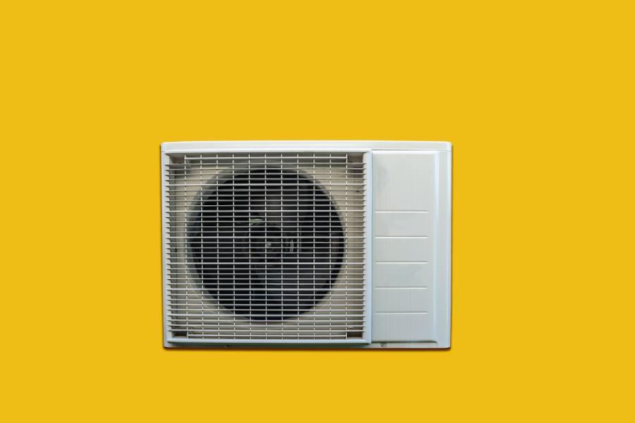 Photo illustration of air conditioning window unit on yellow background