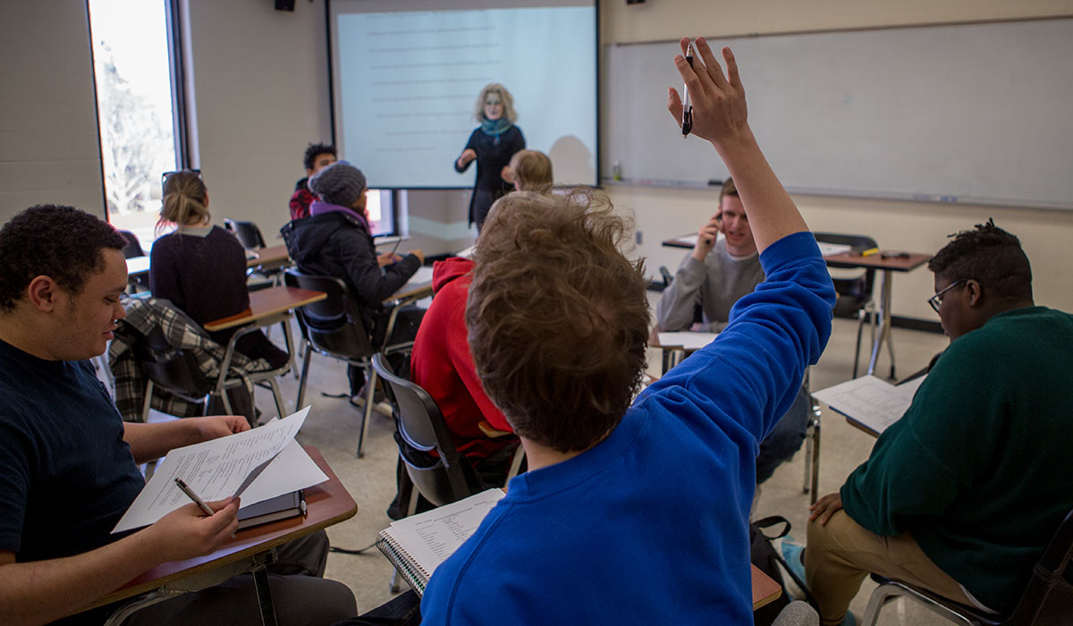 An ENGL 351 student raises his hand to ask Kij Johnson, associate professor of English, a question.