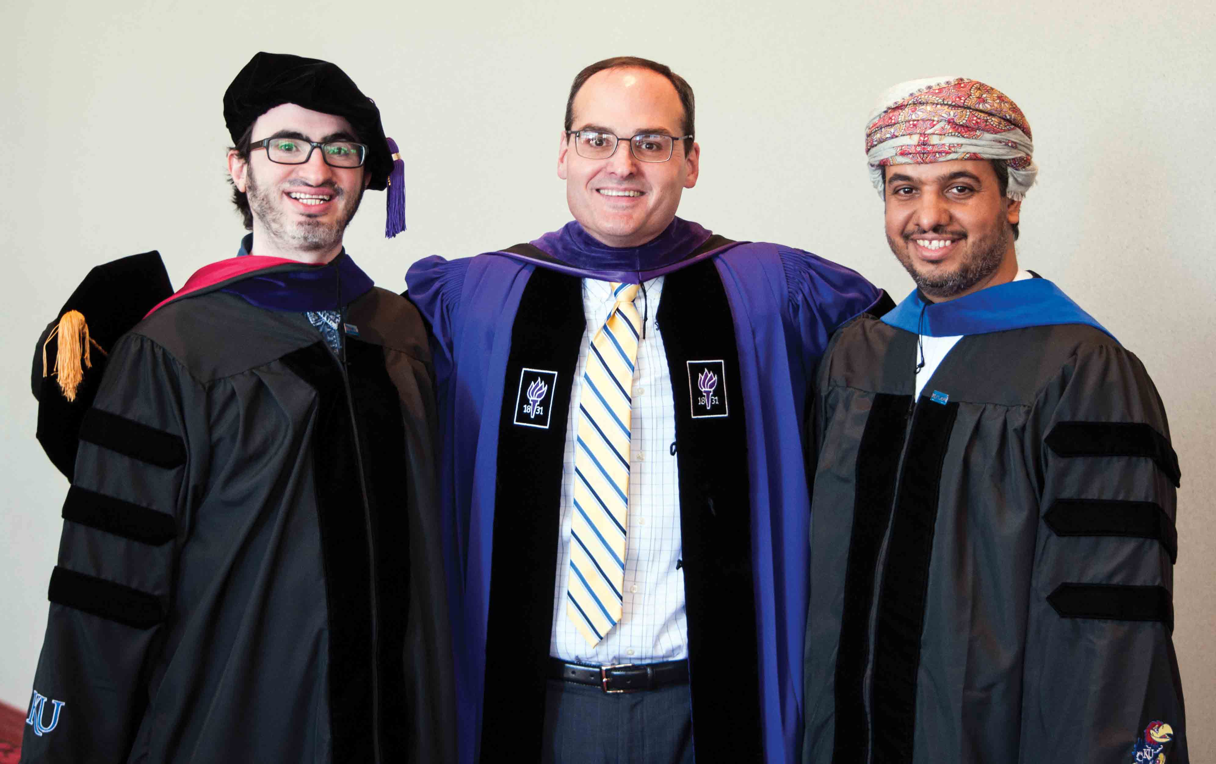 Dean Stephen Mazza, center, with two School of Law alumni