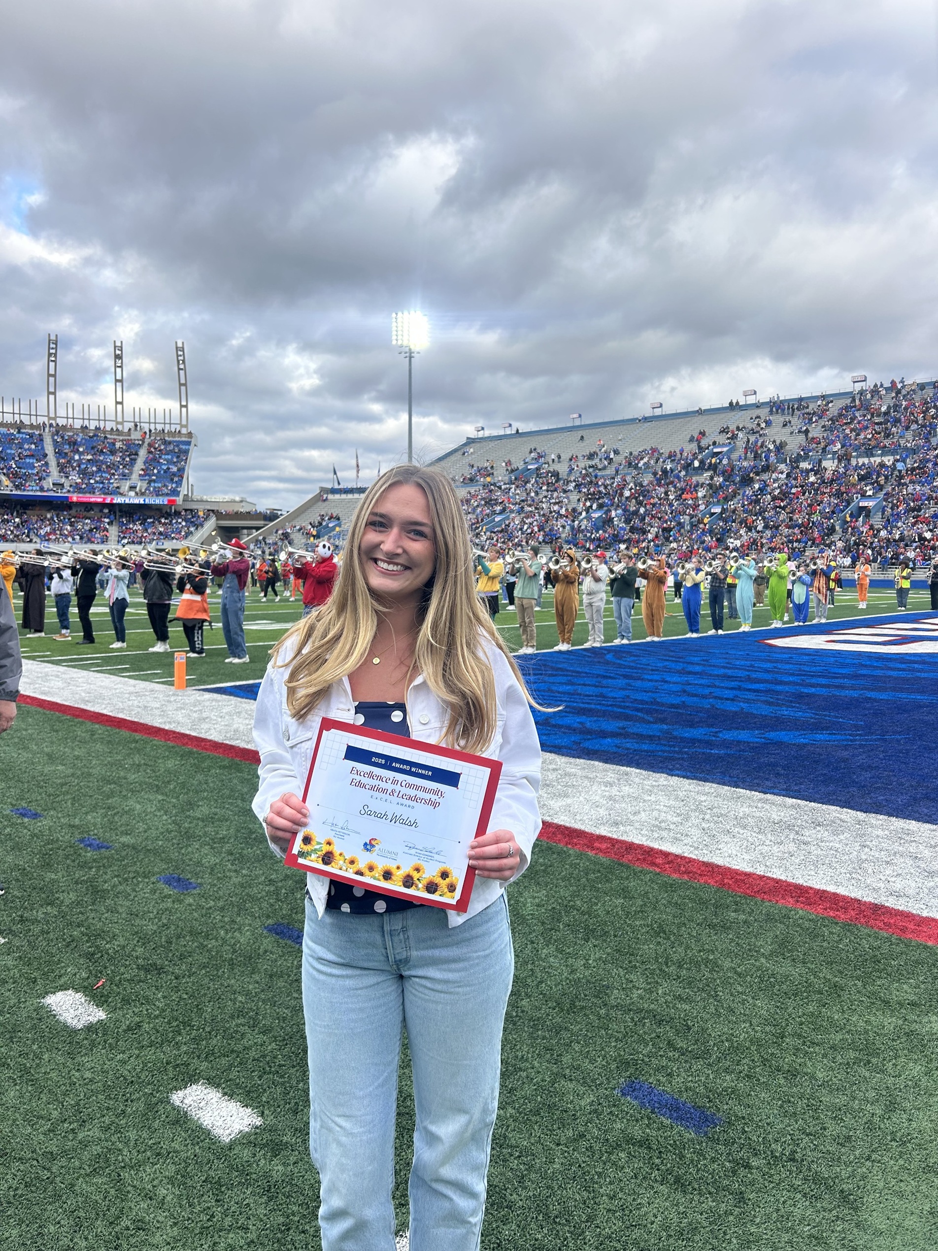 Sarah Walsh holds her award certificate