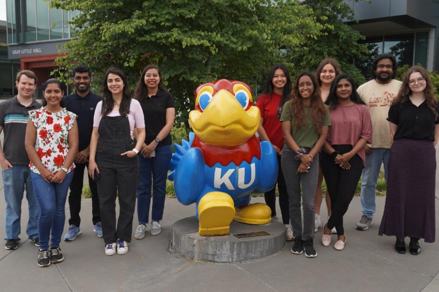 Group photo of KU chemistry scholarship recipients with Jayhawk mascot.