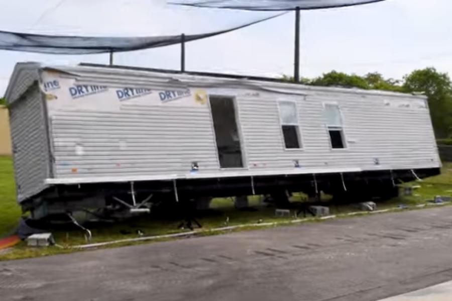 A tilting manufactured home at a wind-testing facility.