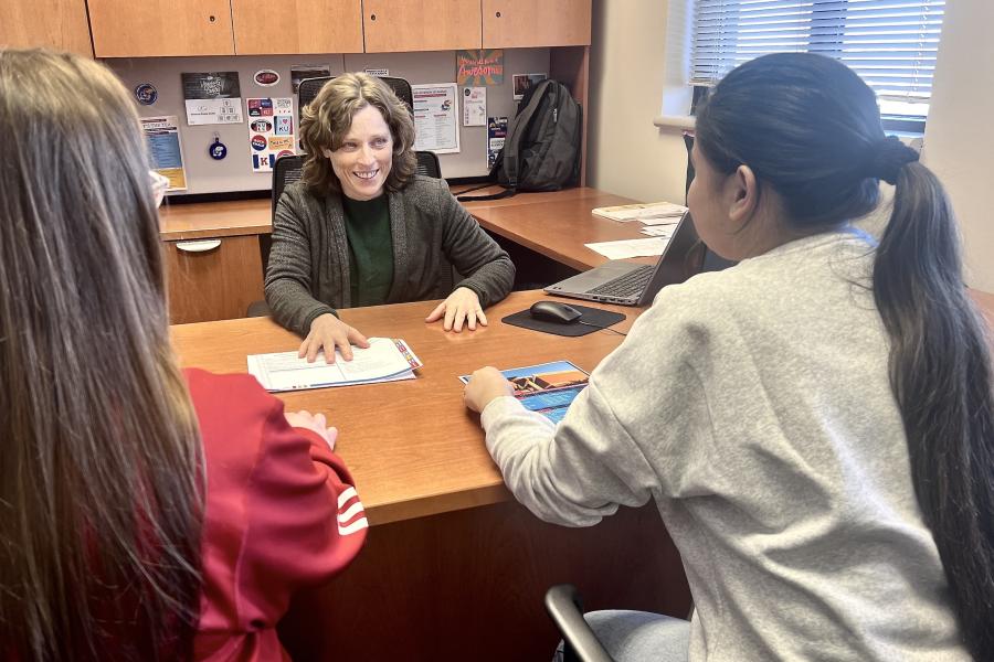 Recruiter meets with students to discuss academic programs.