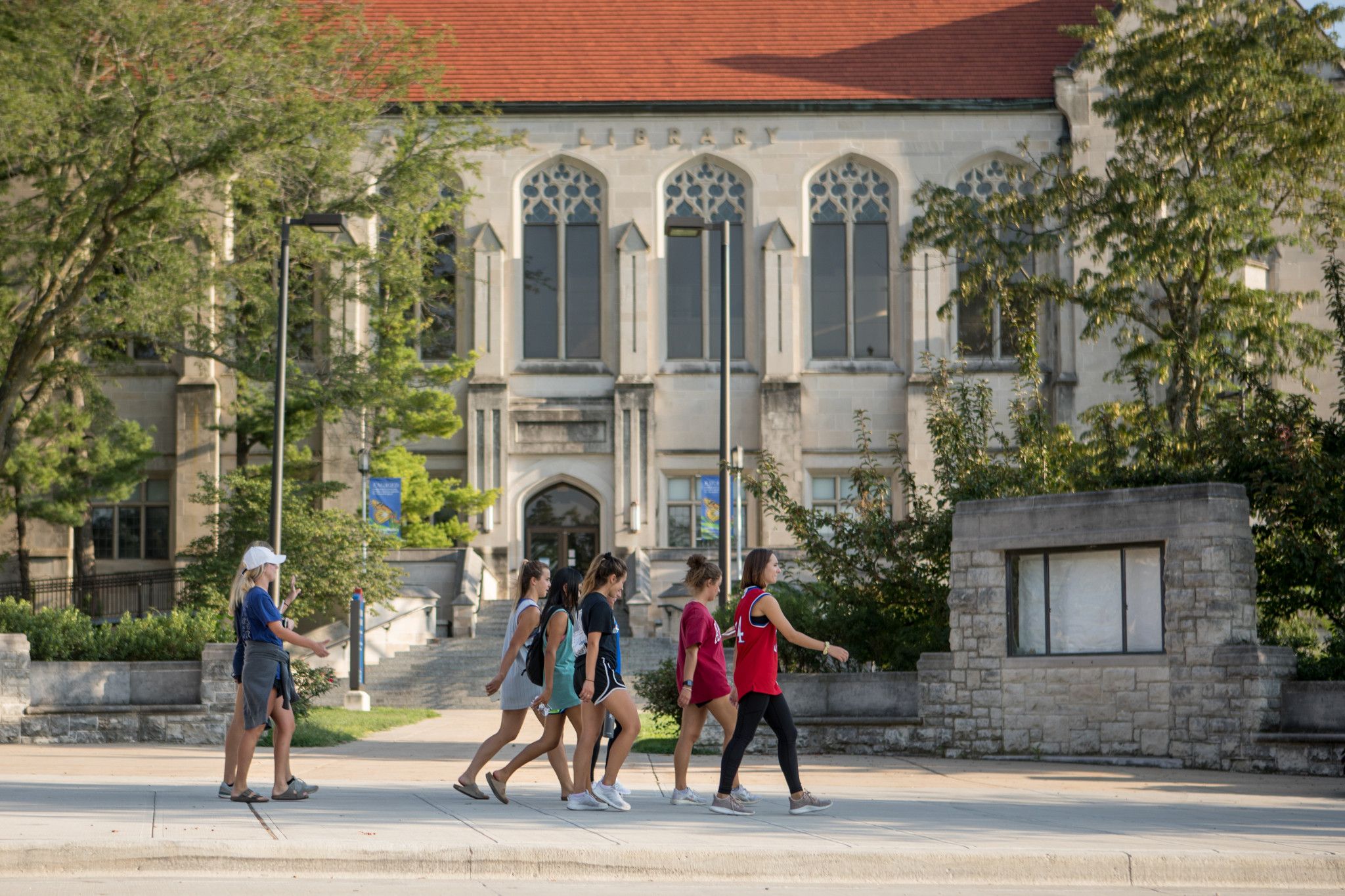 Students walk in front of Watson Library