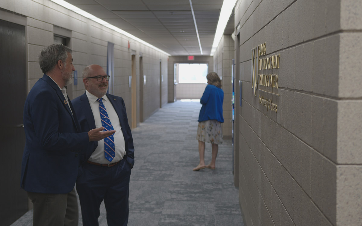 Stuart Day and Darin Beck talk in the hallway of KLETC's new training site at the KU Edwards Overland Park campus.