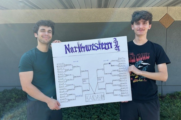 Graham Revare and John Marshall holding the Northwestern University debate tournament bracket.