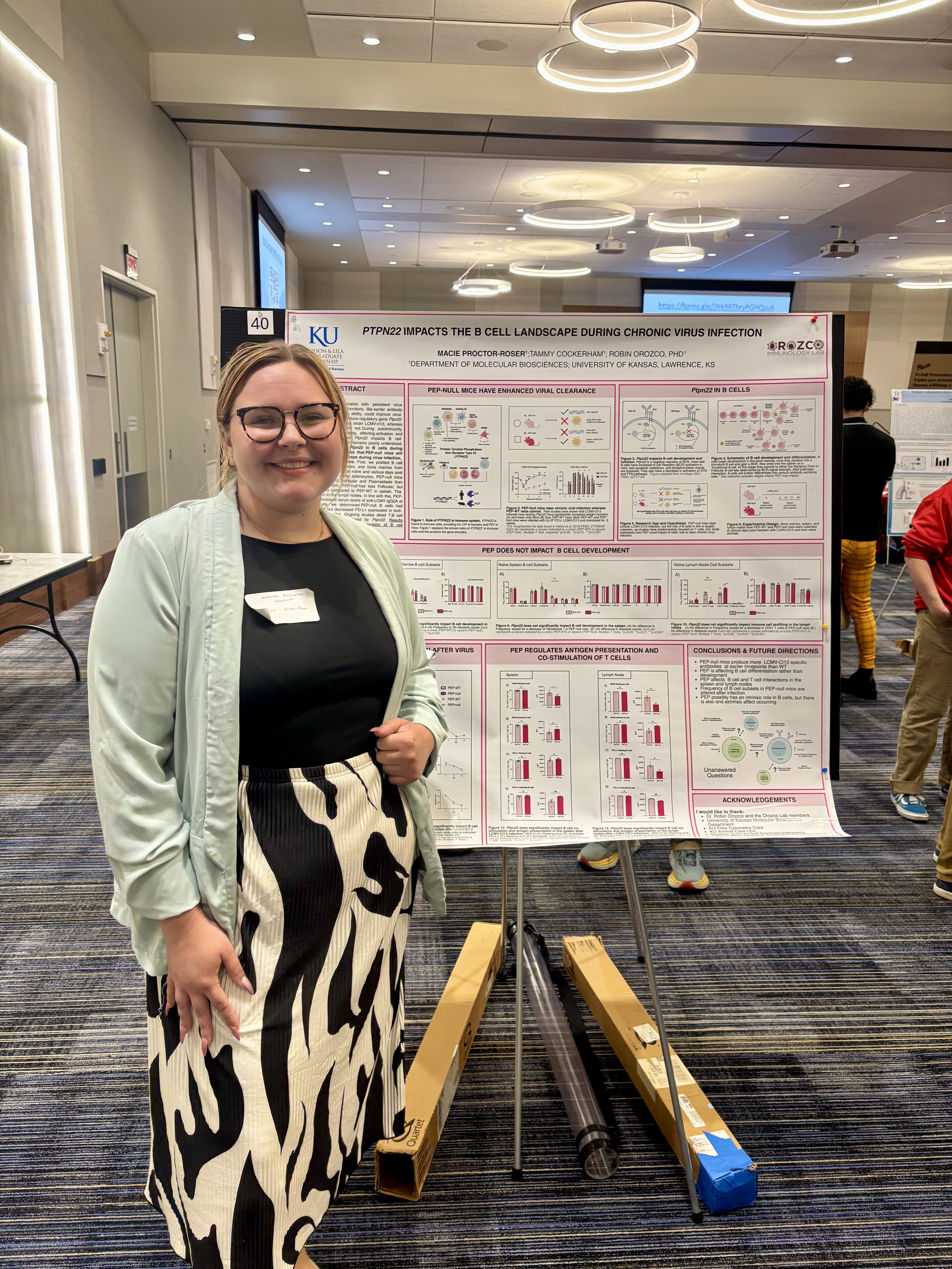 Macie Proctor-Roser stands before her presentation poster 