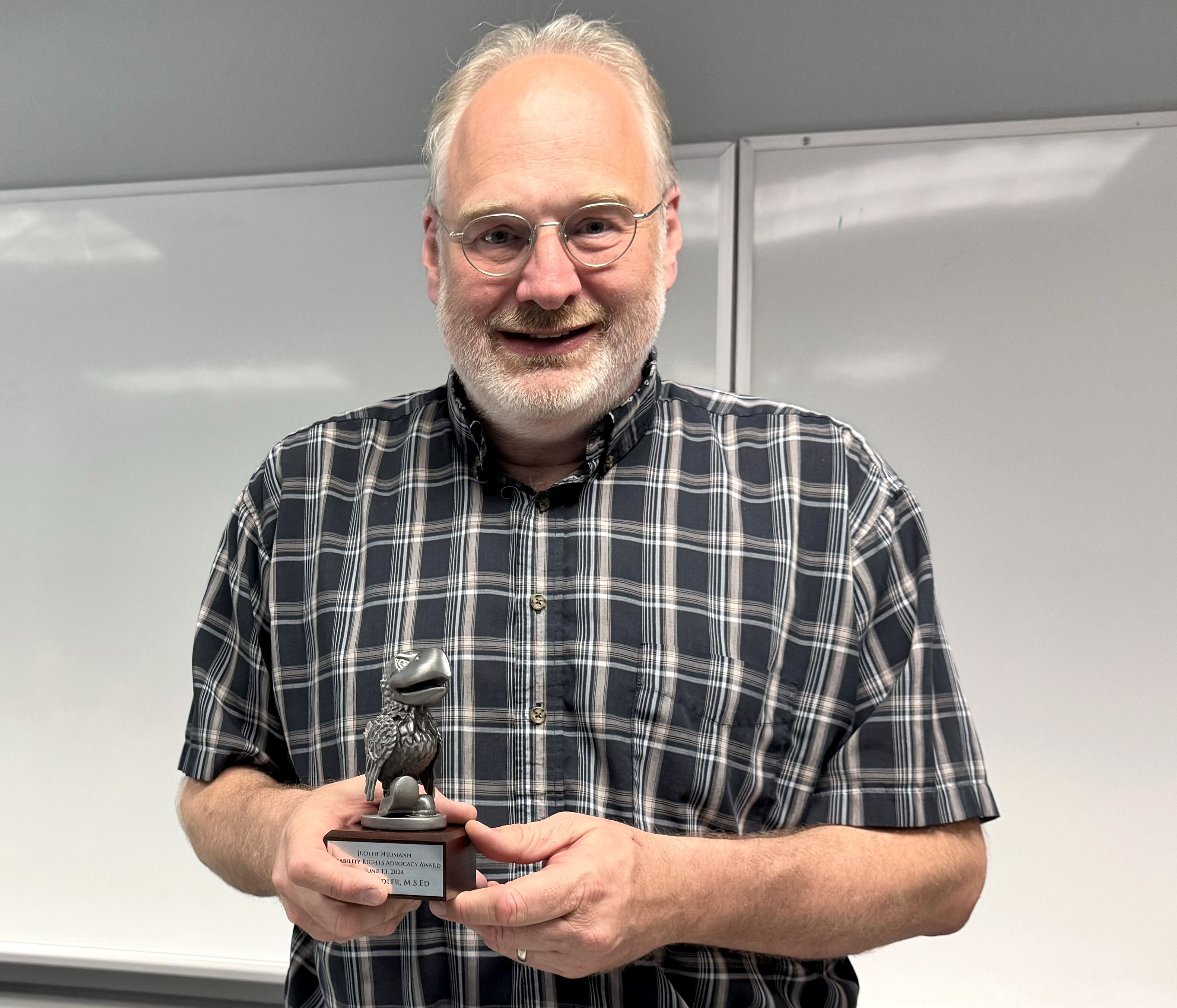 "Sean Swindler holds his award"