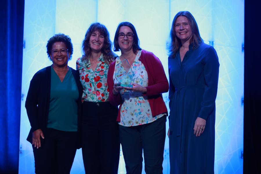 Teresa MacDonald accepts the ASTC award while smiling for a photo with Lisa White.